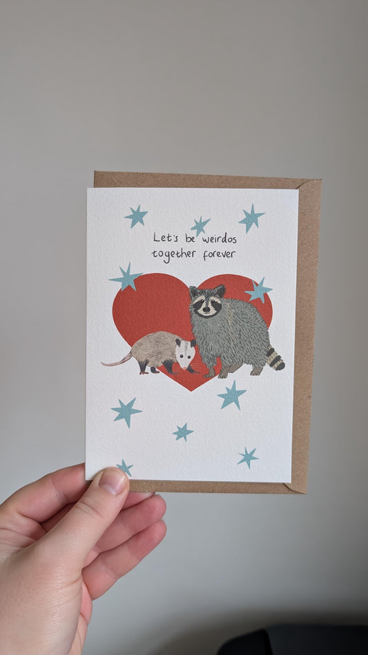 Illustrated funny anniversary card. Raccoon and opossum - let's be weirdos together forever