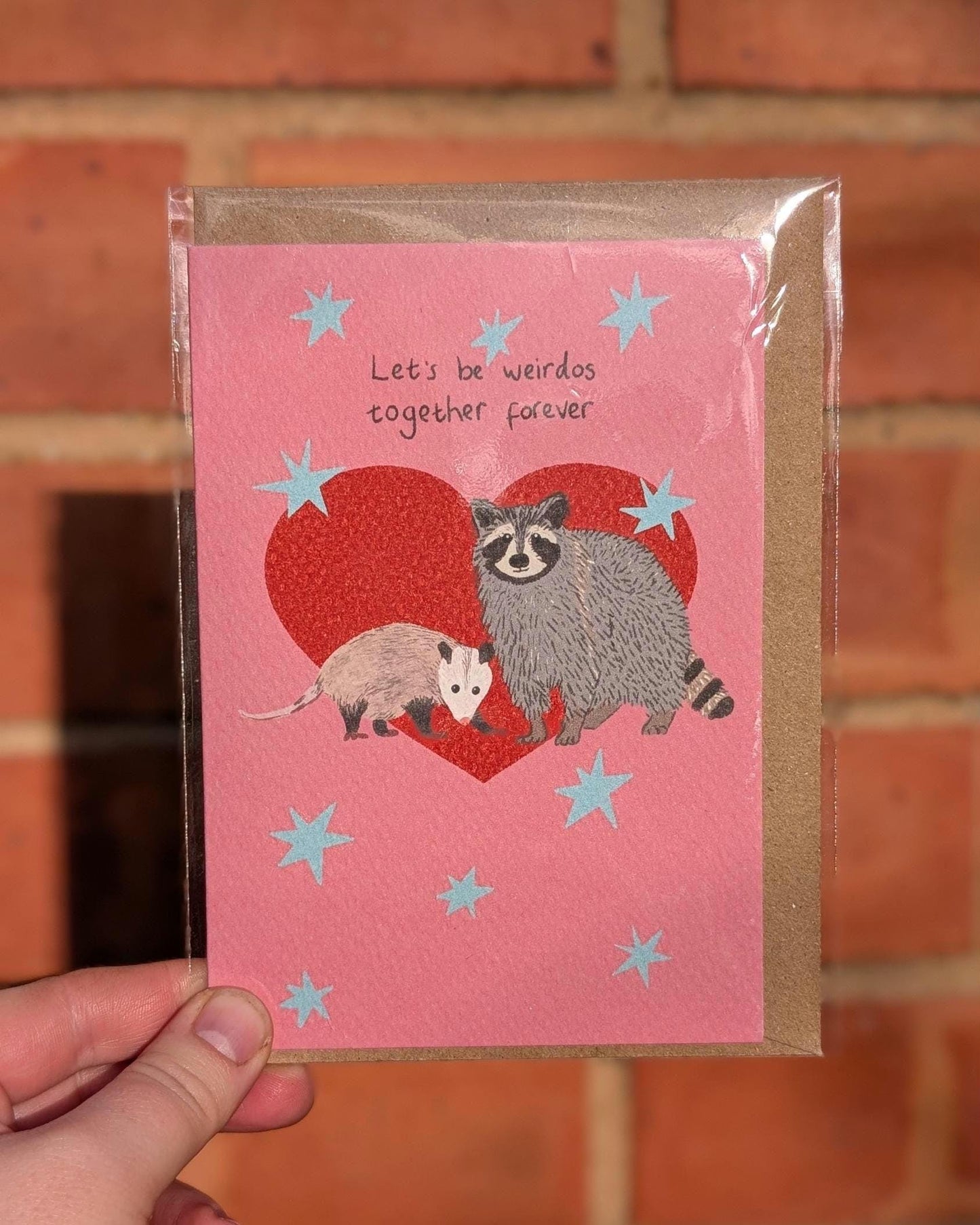 Illustrated funny anniversary card. Raccoon and opossum - let's be weirdos together forever