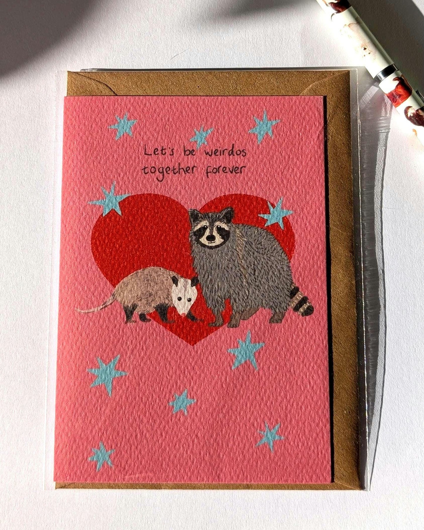 Illustrated funny anniversary card. Raccoon and opossum - let's be weirdos together forever