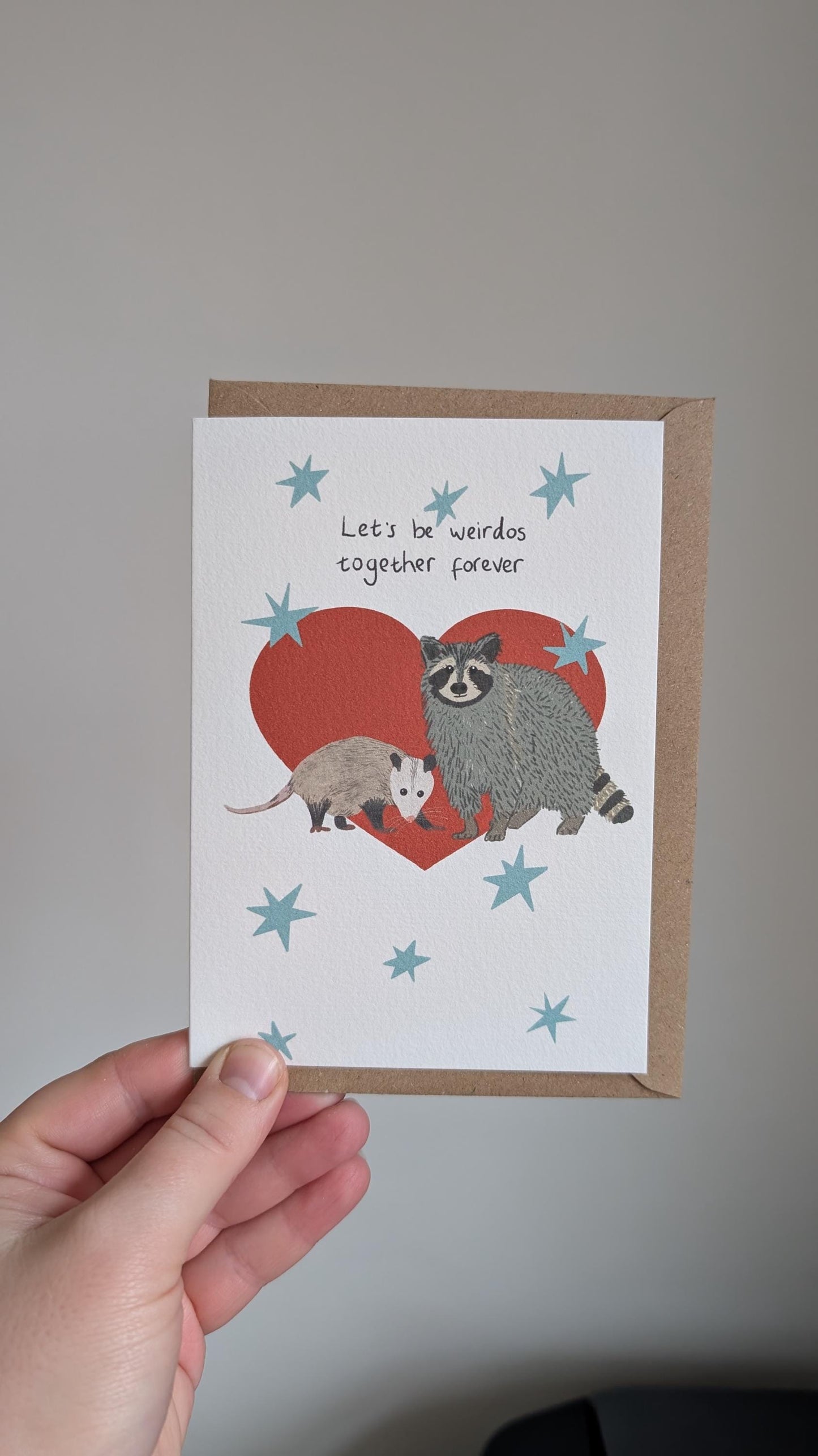 Illustrated funny anniversary card. Raccoon and opossum - let's be weirdos together forever